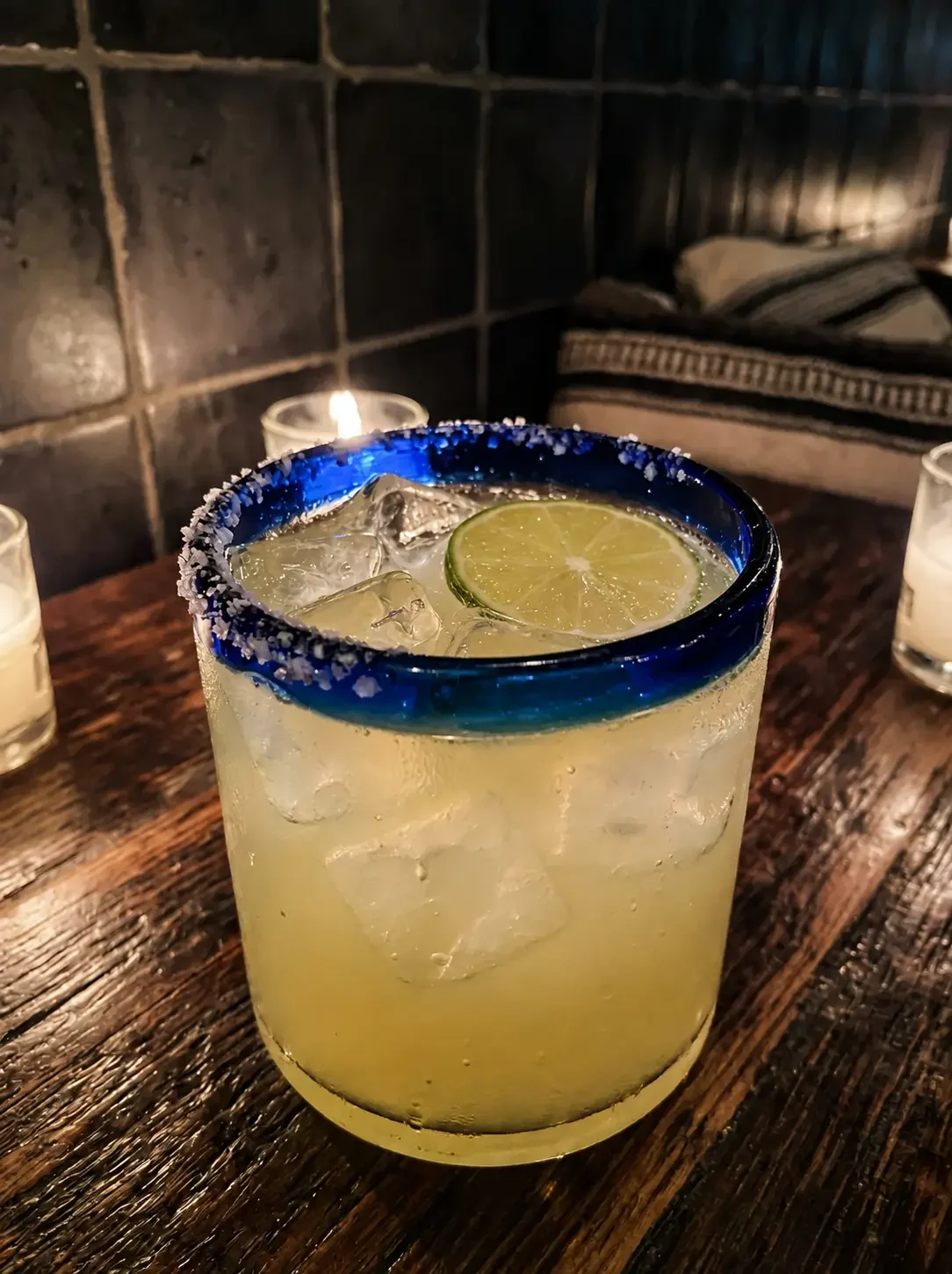 Z Best margarita on the rocks in a salted blue-rimmed glass with a lime wheel at the Iron Cactus tequila bar