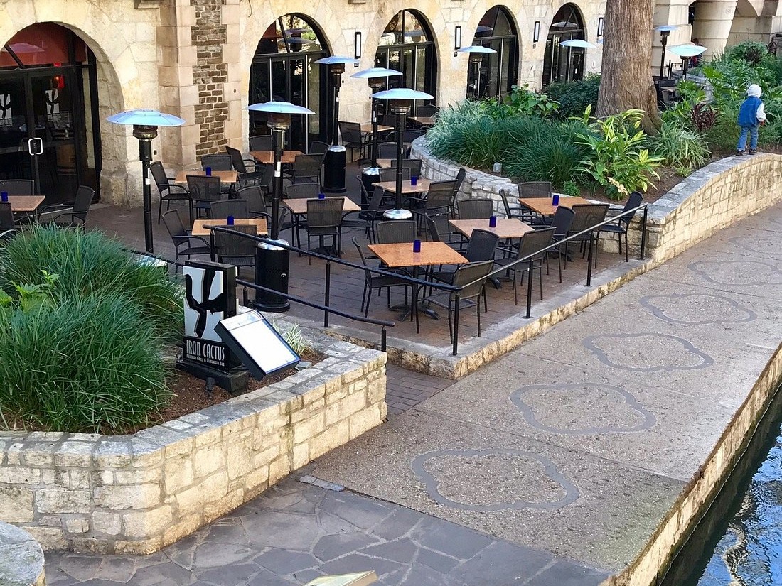 Iron Cactus San Antonio riverside patio and arched stone facade seen from the River Walk